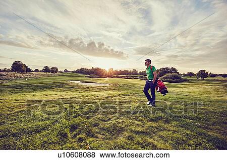 Golfer walking on course, Korschenbroich, Dusseldorf, Germany View Large Photo Image Stock Photo - Golfer walking on course, Korschenbroich, Dusseldorf, Germany. Fotosearch