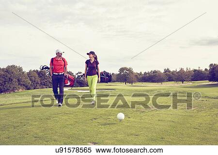Stock Photography - Golfers walking on course, Korschenbroich, Dusseldorf, Germany. Fotosearch