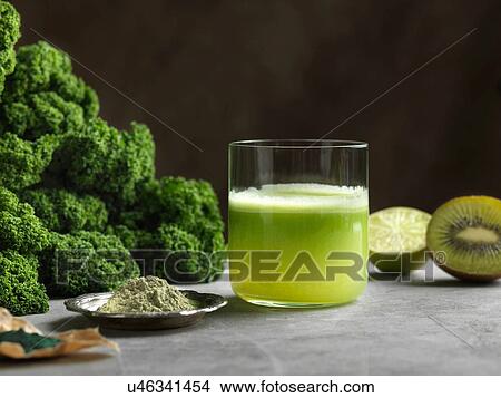Green raw juice with halved kiwi and kale View Large Photo Image Picture - Green raw juice with halved kiwi and kale. Fotosearch