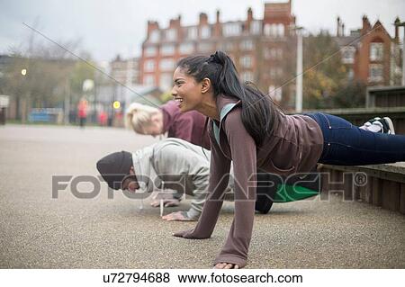 Stock Photo - Group of adults exercising in urban environment. Fotosearch