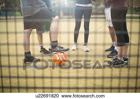 Group of adults standing on urban sports pitch, low section View Large Photo Image Stock Image - Group of adults standing on urban sports pitch, low section. Fotosearch