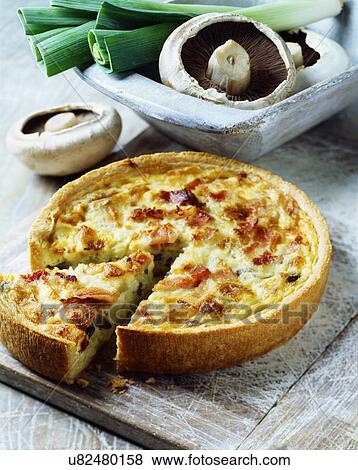 Ham, mushroom and leek quiche on white washed chopping board View Large Photo Image Stock Photo - Ham, mushroom and leek quiche on white washed chopping board. Fotosearch