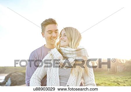 Happy young couple on date at beach View Large Photo Image Stock Photo - Happy young couple on date at beach. Fotosearch