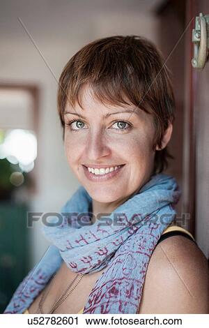 Stock Image - Happy young woman with cropped hair. Fotosearch