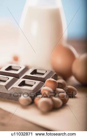 Stock Image - Hazelnuts, chocolate cubes, eggs. Fotosearch
