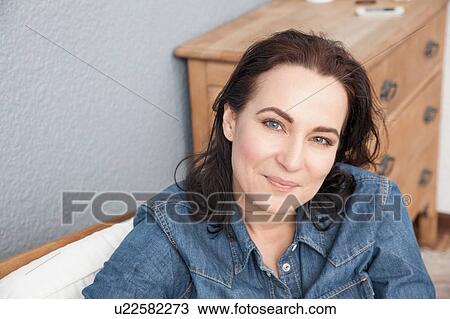 Head and shoulders portrait of a woman mature wearing a denim shirt View Large Photo Image Stock Image - Head and shoulders portrait of a woman mature wearing a denim shirt. Fotosearch
