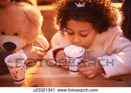 High angle view of girl and teddy bear drinking hot chocolate, looking down View Large Photo Image Stock Image - High angle view of girl and teddy bear drinking hot chocolate, looking down. Fotosearch