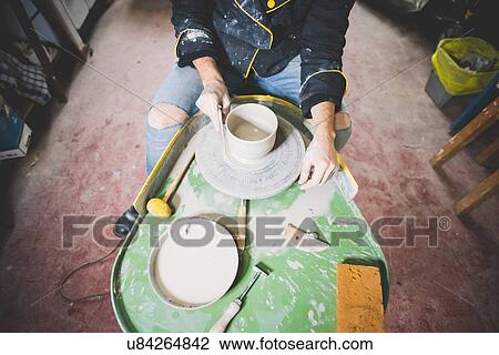 High angle view of mid adult man making clay pot on pottery wheel View Large Photo Image Stock Image - High angle view of mid adult man making clay pot on pottery wheel. Fotosearch