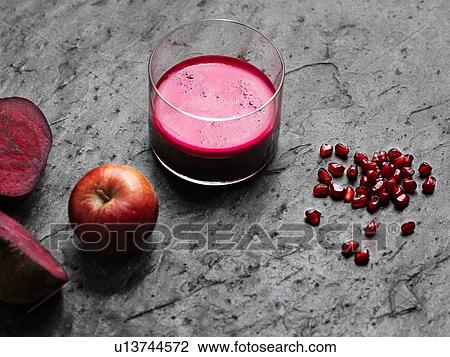 High angle view of purple raw juice, halved beetroot, apple and pomegranate seeds View Large Photo Image Stock Image - High angle view of purple raw juice, halved beetroot, apple and pomegranate seeds. Fotosearch