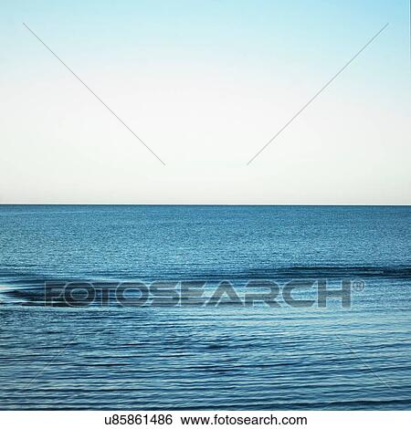 Stock Photograph - Horizon between blue sea and blue sky. Fotosearch