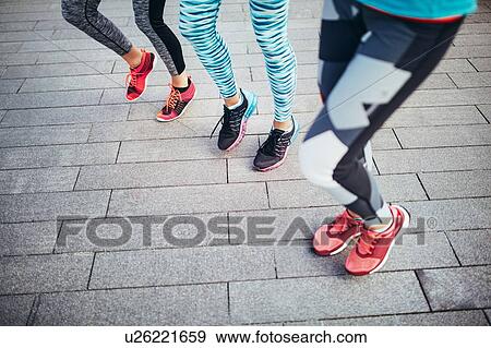 Legs of three female runners running on spot View Large Photo Image Stock Photo - Legs of three female runners running on spot. Fotosearch