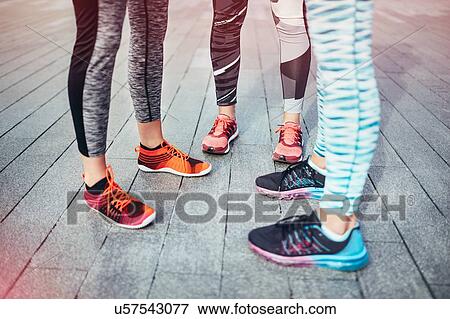 Legs of three female runners standing on wooden pier View Large Photo Image Stock Photo - Legs of three female runners standing on wooden pier. Fotosearch