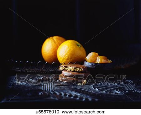 Luxury chocolate coated orange flavoured biscuits and oranges on vintage table, low key View Large Photo Image Stock Image - Luxury chocolate coated orange flavoured biscuits and oranges on vintage table, low key. Fotosearch