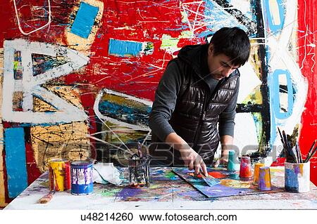 Male artist creating painted artwork View Large Photo Image Stock Image - Male artist creating painted artwork. Fotosearch
