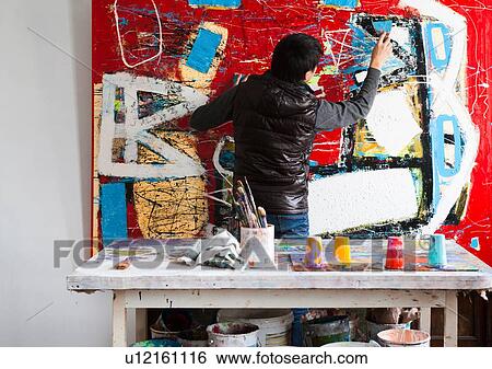 Male artist creating painted artwork View Large Photo Image Stock Photograph - Male artist creating painted artwork. Fotosearch