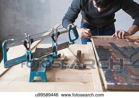 Male artist, framing artwork View Large Photo Image Stock Photograph - Male artist, framing artwork. Fotosearch