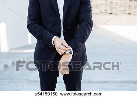 Mature businessman, outdoors, adjusting shirt cuff, mid section View Large Photo Image Stock Photo - Mature businessman, outdoors, adjusting shirt cuff, mid section. Fotosearch