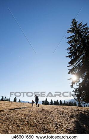 Mature man and toddler daughter walking on hill, Tegernsee, Bavaria, Germany View Large Photo Image Stock Image - Mature man and toddler daughter walking on hill, Tegernsee, Bavaria, Germany. Fotosearch