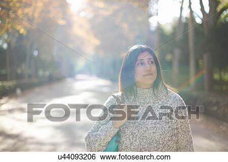 Mature woman on tree lined road, looking away, Seville, Spain View Large Photo Image Stock Photograph - Mature woman on tree lined road, looking away, Seville, Spain. Fotosearch