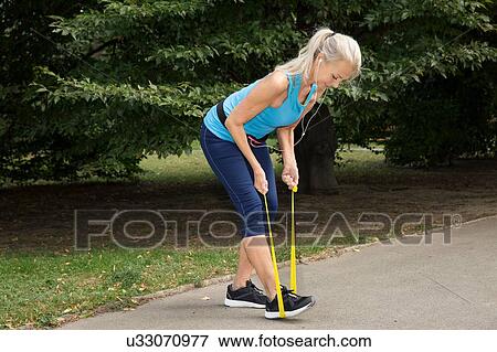 Mature woman resistance training in park View Large Photo Image Stock Photo - Mature woman resistance training in park. Fotosearch