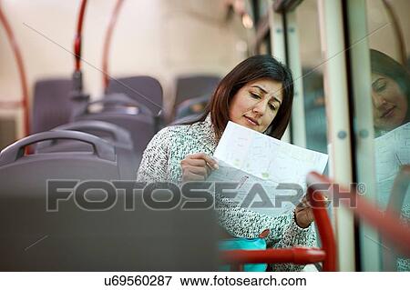 Mature woman sitting on bus, reading letter View Large Photo Image Stock Photo - Mature woman sitting on bus, reading letter. Fotosearch