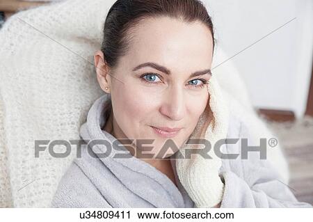 Mature woman touching face with exfoliation glove View Large Photo Image Stock Image - Mature woman touching face with exfoliation glove. Fotosearch