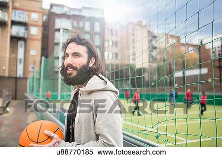 Mid adult man holding basketball View Large Photo Image Stock Photography - Mid adult man holding basketball. Fotosearch