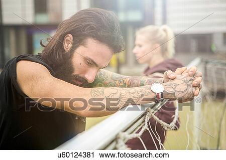 Mid adult man taking a break, leaning on football goal View Large Photo Image Stock Image - Mid adult man taking a break, leaning on football goal. Fotosearch