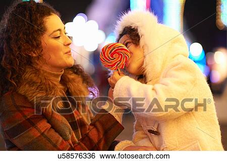 Mother and daughter enjoying lollipop View Large Photo Image Stock Photograph - Mother and daughter enjoying lollipop. Fotosearch