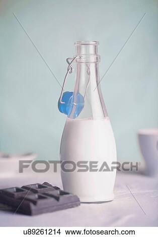 Picture - Opened bottle of milk, chocolate bar. Fotosearch