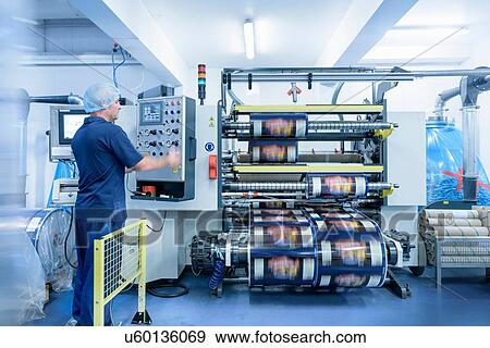 Operator and printing machine in food packaging printing factory View Large Photo Image Stock Photo - Operator and printing machine in food packaging printing factory. Fotosearch