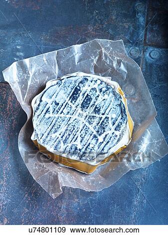 Stock Photo - Overhead view of a goats cheese on metal table. Fotosearch
