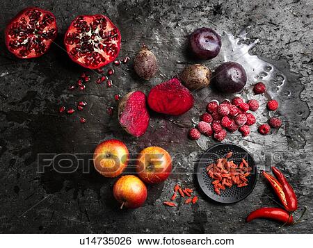 Overhead view of halved red fruit and vegetables on dark background View Large Photo Image Stock Photograph - Overhead view of halved red fruit and vegetables on dark background. Fotosearch