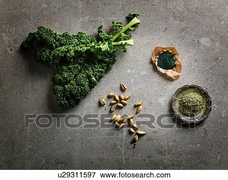 Overhead view of leafy vegetables, cardamom pods and ground supplements View Large Photo Image Stock Photo - Overhead view of leafy vegetables, cardamom pods and ground supplements. Fotosearch