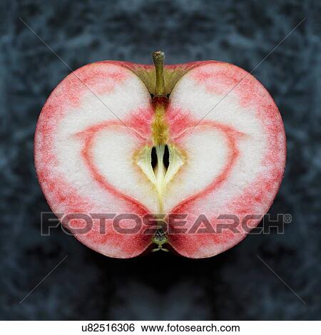 Overhead view of near symmetrical apple half with red heart shape stain View Large Photo Image Stock Photograph - Overhead view of near symmetrical apple half with red heart shape stain. Fotosearch