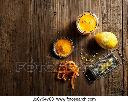 Overhead view of yellow raw juice with grated lemon and carrot on wood grain pattern background View Large Photo Image Stock Image - Overhead view of yellow raw juice with grated lemon and carrot on wood grain pattern background. Fotosearch