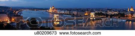 Stock Image - Panoramic view of the Parliament and Chain Bridge at night, Hungary, Budapest. Fotosearch