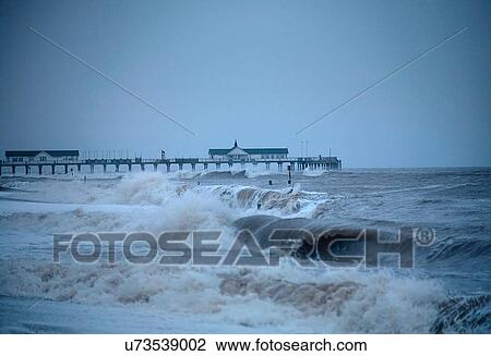 Pier and ocean waves at dusk, Suffolk, UK View Large Photo Image Stock Image - Pier and ocean waves at dusk, Suffolk, UK. Fotosearch