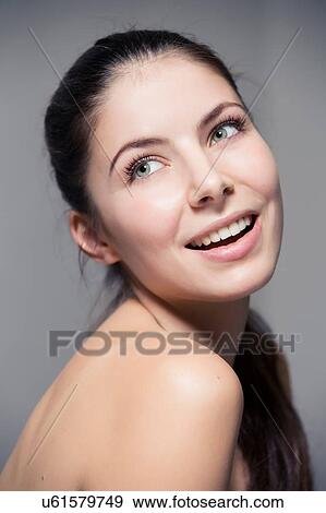 Stock Photo - Portrait of bare shoulder young woman looking away. Fotosearch