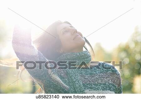 Portrait of carefree mature woman dancing in sunlit park View Large Photo Image Stock Image - Portrait of carefree mature woman dancing in sunlit park. Fotosearch