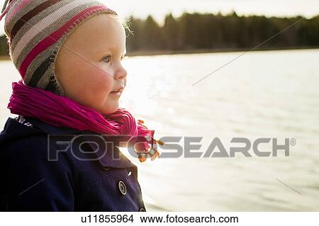 Portrait of cute female toddler looking out over lake View Large Photo Image Picture - Portrait of cute female toddler looking out over lake. Fotosearch