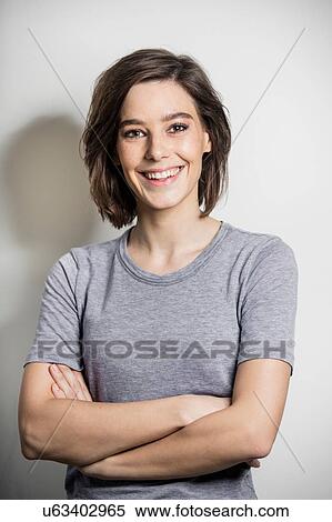 Portrait of happy mid adult woman leaning against wall View Large Photo Image Stock Photography - Portrait of happy mid adult woman leaning against wall. Fotosearch