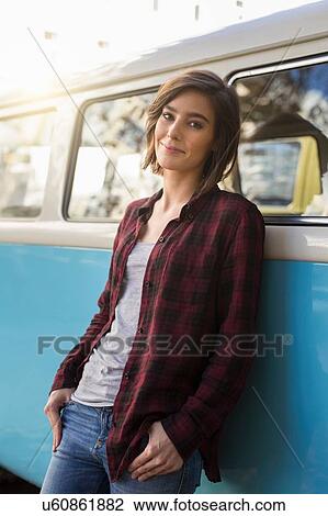 Portrait of mid adult woman leaning against vintage camper van View Large Photo Image Stock Image - Portrait of mid adult woman leaning against vintage camper van. Fotosearch