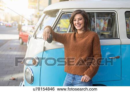 Portrait of mid adult woman leaning against vintage camper van in city View Large Photo Image Stock Photograph - Portrait of mid adult woman leaning against vintage camper van in city. Fotosearch