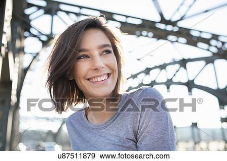 Portrait of mid adult woman on city bridge View Large Photo Image Stock Photo - Portrait of mid adult woman on city bridge. Fotosearch
