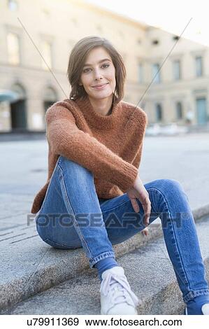Portrait of mid adult woman sitting on sidewalk step View Large Photo Image Stock Photo - Portrait of mid adult woman sitting on sidewalk step. Fotosearch