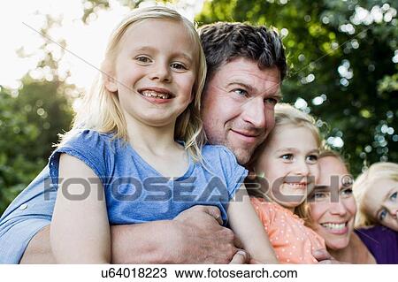 Portrait of parents and three young daughters in park View Large Photo Image Stock Image - Portrait of parents and three young daughters in park. Fotosearch