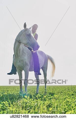 Portrait of woman riding horse bareback in field View Large Photo Image Stock Photo - Portrait of woman riding horse bareback in field. Fotosearch