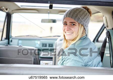 Portrait of young woman in car at beach wearing knit hat View Large Photo Image Stock Photography - Portrait of young woman in car at beach wearing knit hat. Fotosearch