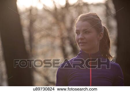 Portrait of young woman in forest looking away View Large Photo Image Picture - Portrait of young woman in forest looking away. Fotosearch
